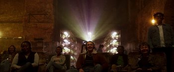 Movie still from “Moon Knight” (2022), directed by Mohamed Diab – A group of people sitting in a room with lights; Wide shot, Low angle