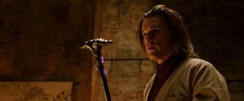 Movie still from “Moon Knight” (2022), directed by Mohamed Diab – A man holding a stick in a dark room; Close Up shot, Over the shoulder angle