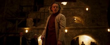 Movie still from “Moon Knight” (2022), directed by Mohamed Diab – A man in a trench coat holding a knife; Medium shot, Low angle