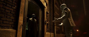 Movie still from “Moon Knight” (2022), directed by Mohamed Diab – A man in a suit and a person in a suit and a person in a suit and a person in a suit and a person in a suit; Medium shot, Over the shoulder angle