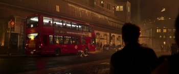 Movie still from “Moon Knight” (2022), directed by Mohamed Diab – A red double decker bus driving down a street; Extreme Wide shot, High angle