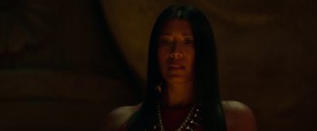 Movie still from “Moon Knight” (2022), directed by Mohamed Diab – A woman with long black hair wearing a necklace and earrings; Close Up shot, Over the shoulder angle