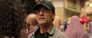 Movie still from “Moon Knight” (2022), directed by Mohamed Diab – A person wearing a hat; Close Up shot, Over the shoulder angle