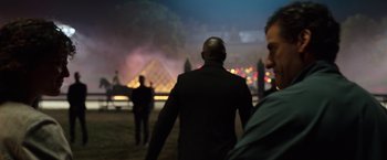 Movie still from “Moon Knight” (2022), directed by Mohamed Diab – Two men walking in front of the louvre at night; Medium shot, Over the shoulder angle