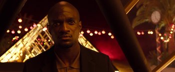 Movie still from “Moon Knight” (2022), directed by Mohamed Diab – A person wearing a suit and tie; Close Up shot, Low angle