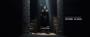 Movie still from “Moon Knight” (2022), directed by Mohamed Diab – A statue of a man in a black robe with a staff; Extreme Wide shot, High angle