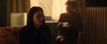 Movie still from “Moon Knight” (2022), directed by Mohamed Diab – Two women sitting in front of a window holding a cup of coffee; Medium shot, Over the shoulder angle