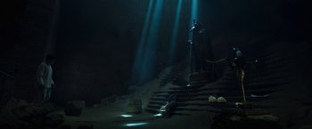 Movie still from “Moon Knight” (2022), directed by Mohamed Diab – The light is shining on the stairs in the cave; Wide shot, Low angle