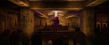 Movie still from “Moon Knight” (2022), directed by Mohamed Diab – A person standing in a room with a light shining on them; Extreme Wide shot, High angle