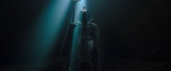 Movie still from “Moon Knight” (2022), directed by Mohamed Diab – A dark room with a light shining on it; Medium shot, Low angle
