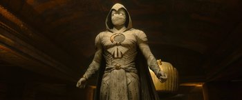 Movie still from “Moon Knight” (2022), directed by Mohamed Diab – A statue of a man dressed in a white costume; Medium shot, Low angle