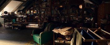 Movie still from “Moon Knight” (2022), directed by Mohamed Diab – A room filled with lots of books and a pile of papers; Wide shot, High angle