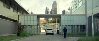Movie still from “Moon Knight” (2022), directed by Mohamed Diab – A man walking down a street with a car in front of him; Extreme Wide shot, Low angle