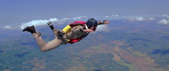 Movie still from “Moonraker” (1979), directed by Lewis Gilbert – A man in the air with a parachute; Wide shot, Low angle