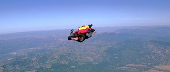 Movie still from “Moonraker” (1979), directed by Lewis Gilbert – A man in the air with a parachute; Extreme Wide shot, High angle
