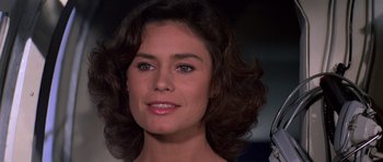 Movie still from “Moonraker” (1979), directed by Lewis Gilbert – A woman's face in a dark room; Close Up shot, Over the shoulder angle