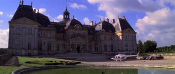 Movie still from “Moonraker” (1979), directed by Lewis Gilbert – An old building with a boat parked in front of it; Extreme Wide shot, Low angle