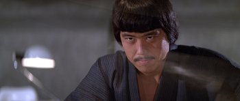 Movie still from “Moonraker” (1979), directed by Lewis Gilbert – A person wearing a wig; Close Up shot, Low angle