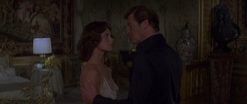 Movie still from “Moonraker” (1979), directed by Lewis Gilbert – A man and a woman standing next to each other; Medium shot, Over the shoulder angle