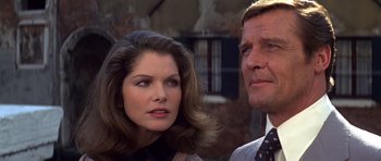 Movie still from “Moonraker” (1979), directed by Lewis Gilbert – A man and a woman standing next to each other; Close Up shot, Low angle