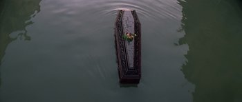 Movie still from “Moonraker” (1979), directed by Lewis Gilbert – An empty casket floating on top of a body of water; Extreme Wide shot, Overhead angle