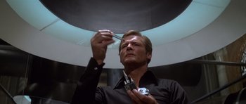 Movie still from “Moonraker” (1979), directed by Lewis Gilbert – A man holding a pair of shears in his hands; Close Up shot, Low angle