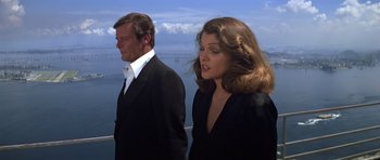 Movie still from “Moonraker” (1979), directed by Lewis Gilbert – A man and a woman standing next to each other; Medium shot, Low angle