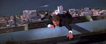 Movie still from “Moonraker” (1979), directed by Lewis Gilbert – A man in a suit falling off of a building; Wide shot, Overhead angle