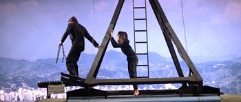 Movie still from “Moonraker” (1979), directed by Lewis Gilbert – A man and a woman are climbing a ladder; Wide shot, Low angle