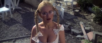 Movie still from “Moonraker” (1979), directed by Lewis Gilbert – A woman with pigtails wearing glasses and a white dress; Close Up shot, Low angle