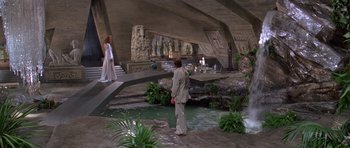 Movie still from “Moonraker” (1979), directed by Lewis Gilbert – A man and a woman standing next to each other in front of a fountain; Extreme Wide shot, High angle
