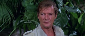 Movie still from “Moonraker” (1979), directed by Lewis Gilbert – A person wearing a white shirt; Close Up shot, Over the shoulder angle