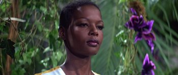 Movie still from “Moonraker” (1979), directed by Lewis Gilbert – A person with short black hair; Close Up shot, Low angle