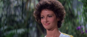 Movie still from “Moonraker” (1979), directed by Lewis Gilbert – A person wearing a white shirt with trees in the background; Close Up shot, Low angle