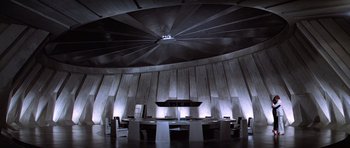 Movie still from “Moonraker” (1979), directed by Lewis Gilbert – A large round table in the middle of a room; Extreme Wide shot, High angle