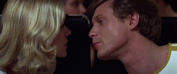 Movie still from “Moonraker” (1979), directed by Lewis Gilbert – A man and a woman face to face in front of each other; Close Up shot, Low angle