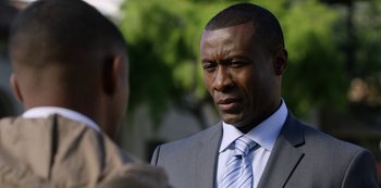 Movie still from “13 Reasons Why” (2017), created by Brian Yorkey – A man in a suit and tie talking to another man in a suit and tie; Close Up shot, Over the shoulder angle