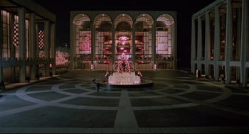 Movie still from “Moonstruck” (1987), directed by Norman Jewison – A fountain in the middle of a courtyard at night; Extreme Wide shot, High angle