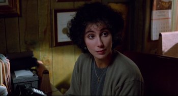 Movie still from “Moonstruck” (1987), directed by Norman Jewison – A person sitting at a table; Close Up shot, Over the shoulder angle