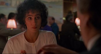 Movie still from “Moonstruck” (1987), directed by Norman Jewison – A person sitting at a table; Close Up shot, Over the shoulder angle