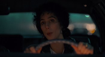 Movie still from “Moonstruck” (1987), directed by Norman Jewison – A woman sitting in the driver's seat of a car; Close Up shot, Over the shoulder angle