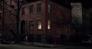 Movie still from “Moonstruck” (1987), directed by Norman Jewison – A red fire hydrant in front of a red brick building; Extreme Wide shot, High angle