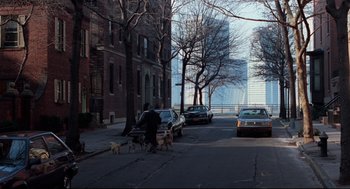 Movie still from “Moonstruck” (1987), directed by Norman Jewison – A man walking his dogs down the street; Extreme Wide shot, High angle