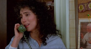 Movie still from “Moonstruck” (1987), directed by Norman Jewison – A person talking on a phone; Close Up shot, High angle