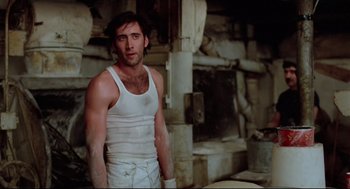 Movie still from “Moonstruck” (1987), directed by Norman Jewison – A man wearing a white shirt and shorts; Medium shot, Low angle