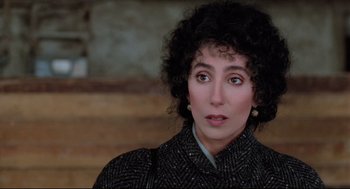 Movie still from “Moonstruck” (1987), directed by Norman Jewison – A person with curly hair wearing a suit; Close Up shot, High angle