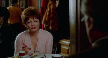 Movie still from “Moonstruck” (1987), directed by Norman Jewison – An older woman sitting at a dinner table eating; Close Up shot, Over the shoulder angle
