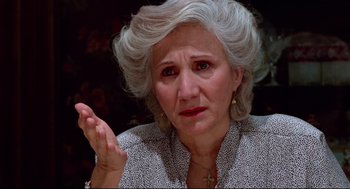 Movie still from “Moonstruck” (1987), directed by Norman Jewison – An older woman with gray hair is looking at the camera; Close Up shot, High angle