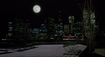 Movie still from “Moonstruck” (1987), directed by Norman Jewison – A full moon rises over a city at night; Extreme Wide shot, High angle