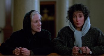 Movie still from “Moonstruck” (1987), directed by Norman Jewison – Two women sitting next to each other at a table; Close Up shot, Low angle
